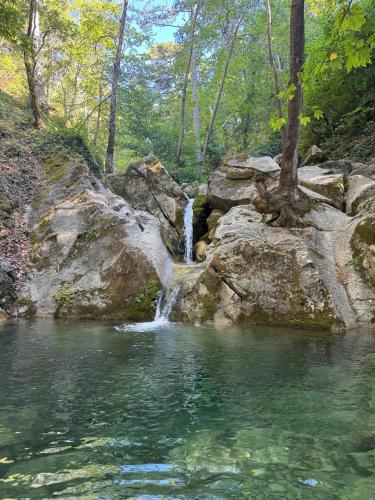 a waterfall in the middle of a pool of water at İnziva Butik Otel in Evciler