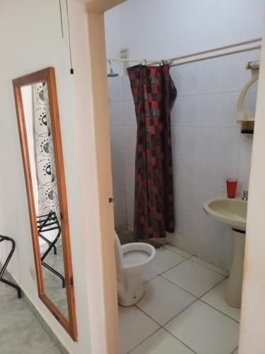 a bathroom with a toilet and a sink at Dandimayo Hotel Bar & Restaurant in Serekunda