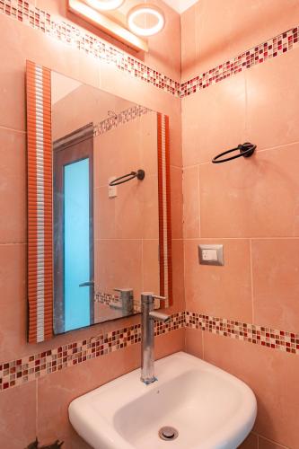 a bathroom with a sink and a mirror at Finca La Macarena, Playas Villamil in Playas