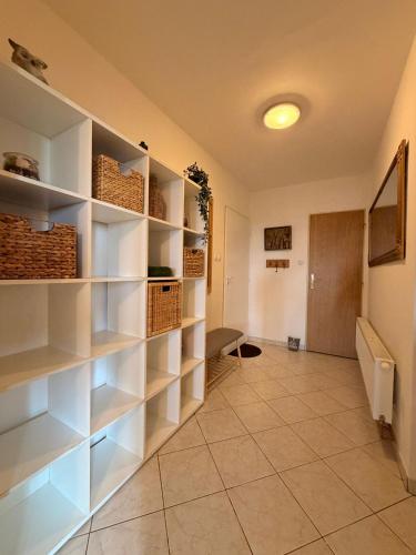 a hallway with white shelves in a room at Búda u Totevú in Skalica