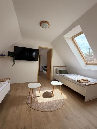 a bedroom with two stools and a bed and a window at Búda u Totevú in Skalica