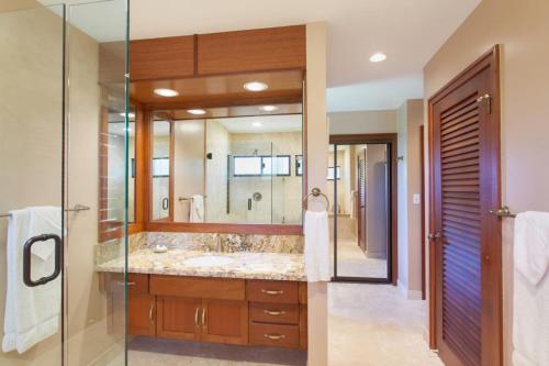 a bathroom with a large sink and a mirror at 411 Ridge in Kahana
