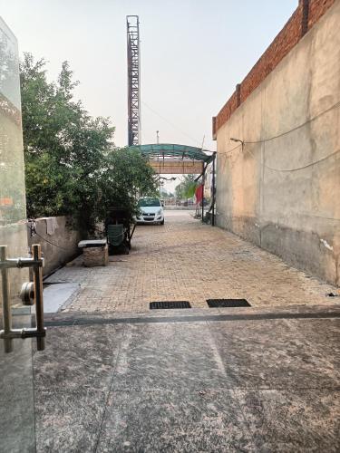 a car parked in a parking lot next to a building at Hotel Green in Bhucho
