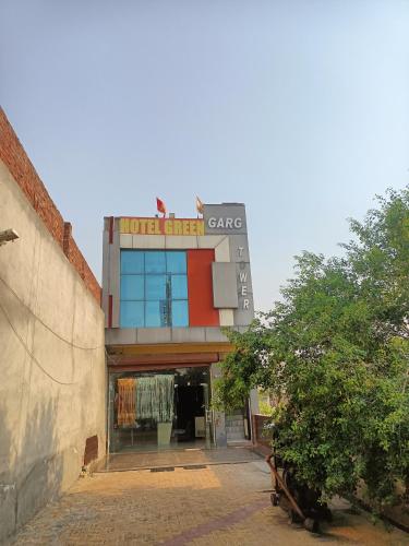 a building with a sign that reads hotel first care at Hotel Green in Bhucho