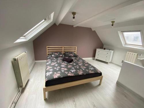 a bedroom with a bed in a attic at L'Apart Amiens in Le Treuil