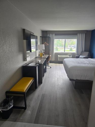 a hotel room with a bed and a desk at Rodeway Inn in Portage