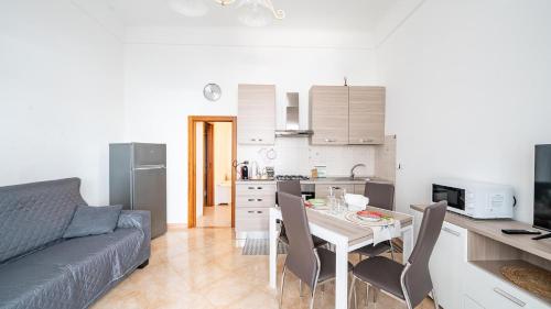 a kitchen and a living room with a table and chairs at Casa Alessia by Rentbeat in Cisternino