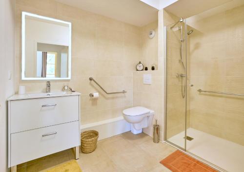 a bathroom with a shower and a toilet and a sink at Résidence de Bergerac in Bergerac