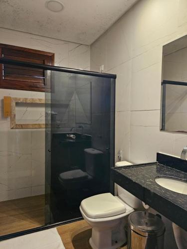 a bathroom with a shower and a toilet and a sink at Sítio do Bosco Park in Tianguá