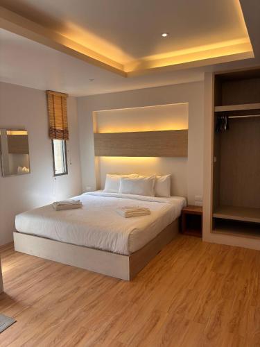 a bedroom with a large white bed in a room at Breezy Studio Aonang in Ao Nang Beach