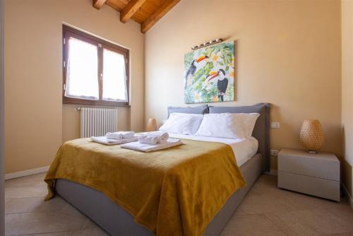 a bedroom with a bed with two towels on it at IseoLakeRental - Casa Lani in Costa Volpino