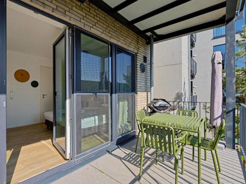 a patio with a table and chairs on a balcony at Apartment Seebrise by Interhome in Lembruch