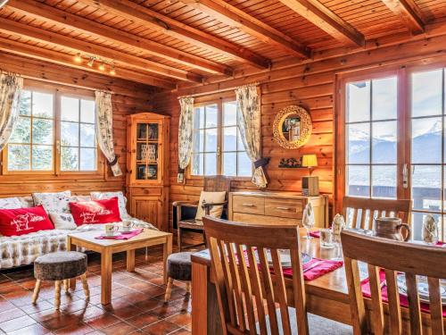 a living room with a couch and a table at Chalet Chalet Le Trèfle by Interhome in Salins