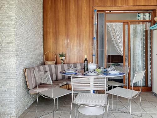 a dining room with a table and chairs and a couch at Villa Villa Bikini by Interhome in Saint-Gingolph