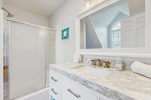 a white bathroom with a sink and a mirror at York Starfish Haven in York