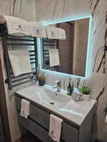 a bathroom with a sink and a mirror at Yerevan Street hotel in Yerevan