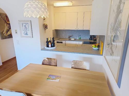a kitchen with a wooden table and a counter at Apartment Toissa A6 by Interhome in Salouf