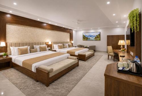 a hotel room with two beds and a television at Hotel Radiance Park Delhi Airport in New Delhi