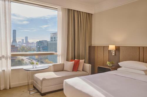a hotel room with a bed and a window at Hyatt Regency Belgrade in Belgrade