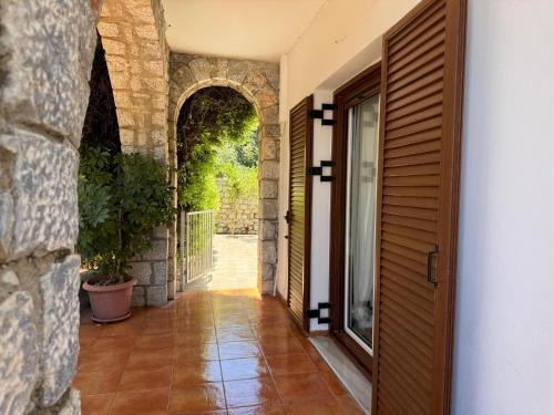 an entrance to a house with a wooden door at Jassemi Studio in Mavrovouni