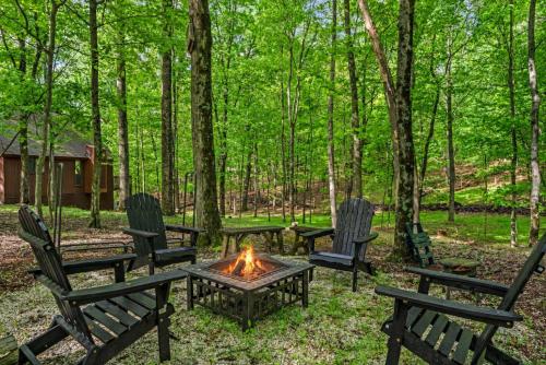 a group of chairs around a campfire in the woods at DogFriendly wHot Tub Fire Pit Resort Access in Hedgesville