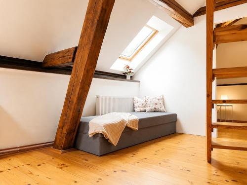 a bed in a room with a window at Symbiola River Apartments in Děčín