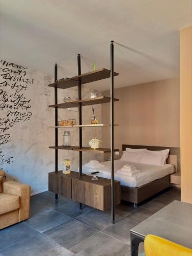 a bedroom with a bed and a book shelf at Sibilla Suite - Manu Maison in Parma