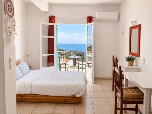 a bedroom with a bed and a view of the ocean at Casa Spartines in Votsi