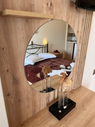 a bedroom with a large mirror on the wall at Isidora Hotel in Agia Marina Aegina