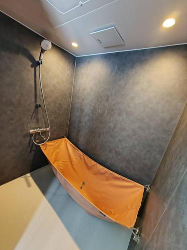an empty room with an orange tent on the wall at 五島宿Seina in Goto