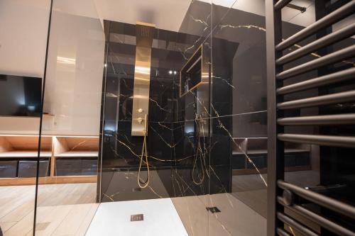 a glass elevator in a room with a couch at La Bulle Prestige in Montargis