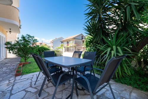 a blue table and chairs on a patio at Verde Mar Apartment in Tivat