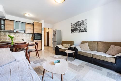 a living room with a couch and a table at Verde Mar Apartment in Tivat