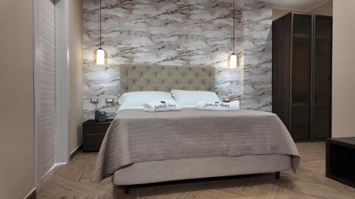 a bedroom with a bed with two pillows on it at Airfield Hotel & Spa in Vibo Valentia