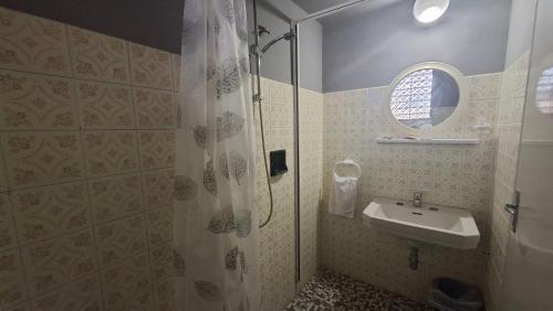 a bathroom with a shower and a sink at Hotel Astoria in Riccione