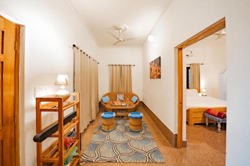 a small room with a bed and a table at Adviga by The StayCationer in Dehradun