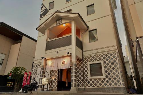 a building with an entrance to a store at MATSUMOTO CASTLE hostel in Matsumoto