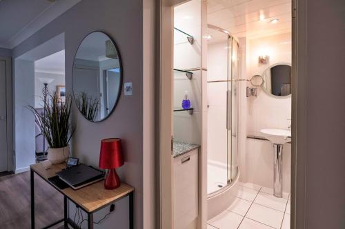 a bathroom with a shower and a sink and a mirror at Finest Retreats - Gleneagles in Auchterarder
