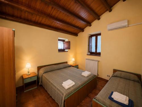 a bedroom with two beds and two night stands at Agriturismo L'Antica Vigna in Randazzo
