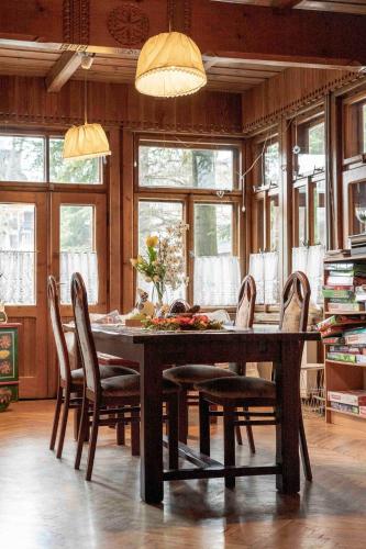 a dining room with a wooden table and chairs at Willa Orla in Zakopane
