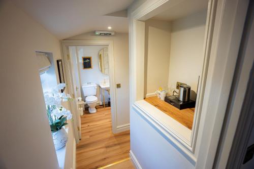 a hallway with a bathroom with a toilet in it at The Huntsman in Norwich