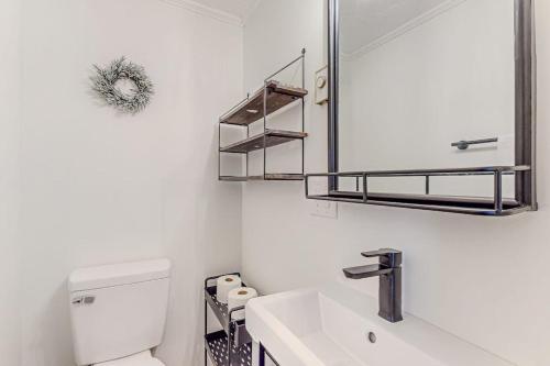 a white bathroom with a sink and a mirror at The Beech Hut in Beech Mountain