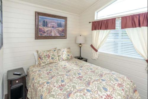 a bedroom with a bed and a window at 49er Village in Plymouth