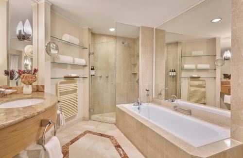 a bathroom with a large tub and a sink at Hyatt Regency Belgrade in Belgrade
