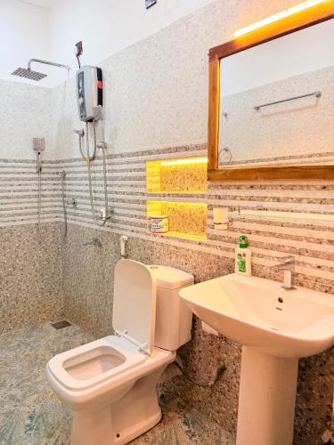 a bathroom with a toilet and a sink at Arugam Bay Resort in Arugam Bay
