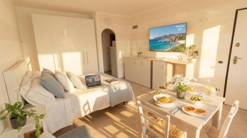 a living room with a bed and a table with a laptop at The Sea Wind Apartments & Suites in Palau