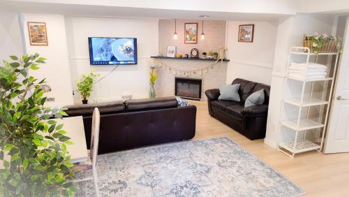 a living room with a couch and a fireplace at Applewood Gardens Apartment in Mississauga