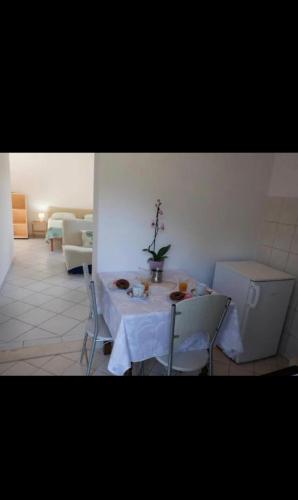 a room with a table and chairs in a room at podskoj apartment in Saplunara