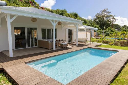 a villa with a swimming pool and a house at Villa Duna 2 Bedrooms Pool & Tropical Atmosphere in Sainte-Anne