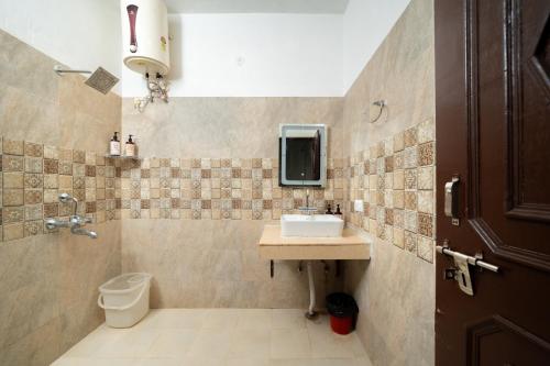 a bathroom with a sink and a toilet at Adviga by The StayCationer in Dehradun